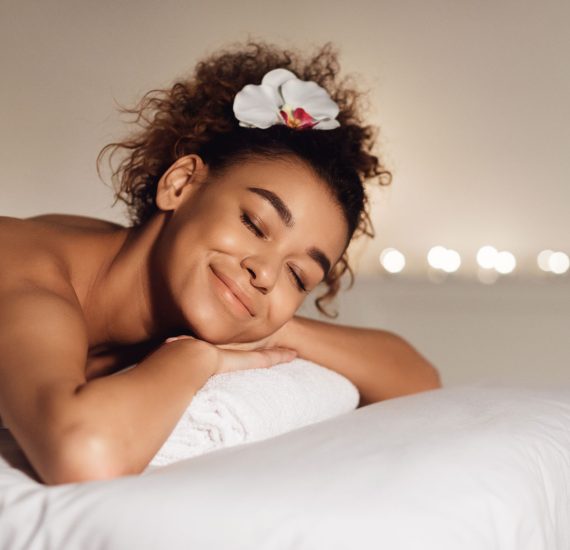 massage-african-american-girl-relaxing-in-spa-FPA9EM2.jpg